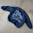 Blue hoodie with white text on a concrete surface